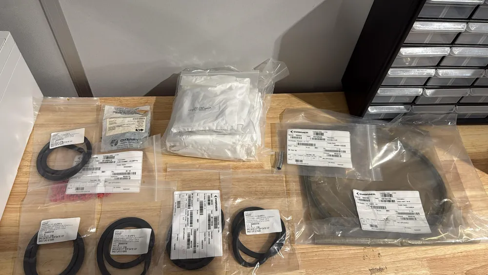 Several bagged and labelled aircraft components laid out on the packing bench